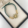 Pulsera tejida con herraje de timon con circones verdes  Oro amarillo 18k 3,1 Gr