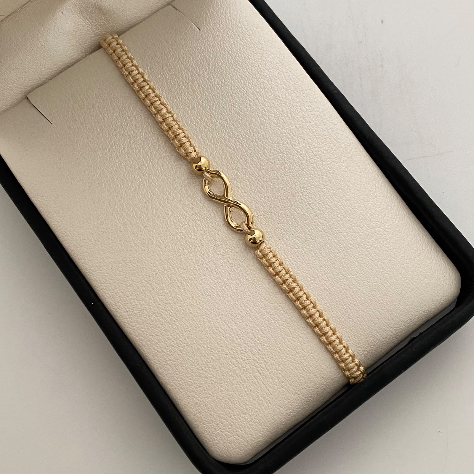 Pulsera tejida Infinito bolas lisas 4mm beige Oro amarillo 18k 0,6 Gr