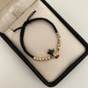 Pulsera tejida con herraje de pato y balines diamantados  Tres oros 18k 3,05 Gr