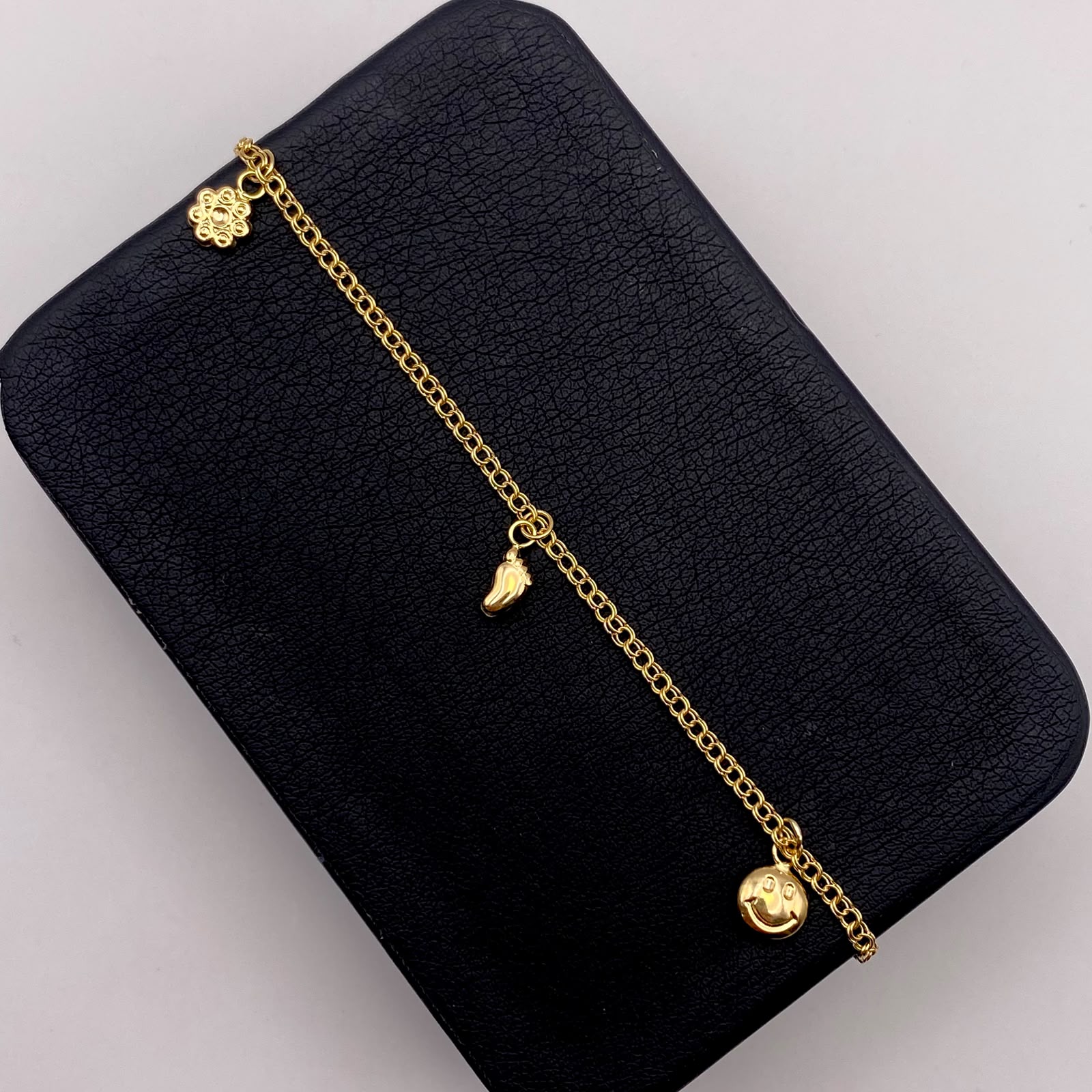 Tobillera aro seguido dijes Oro amarillo 18k 3,40 Gr / 27 Cm  Broche 0,40