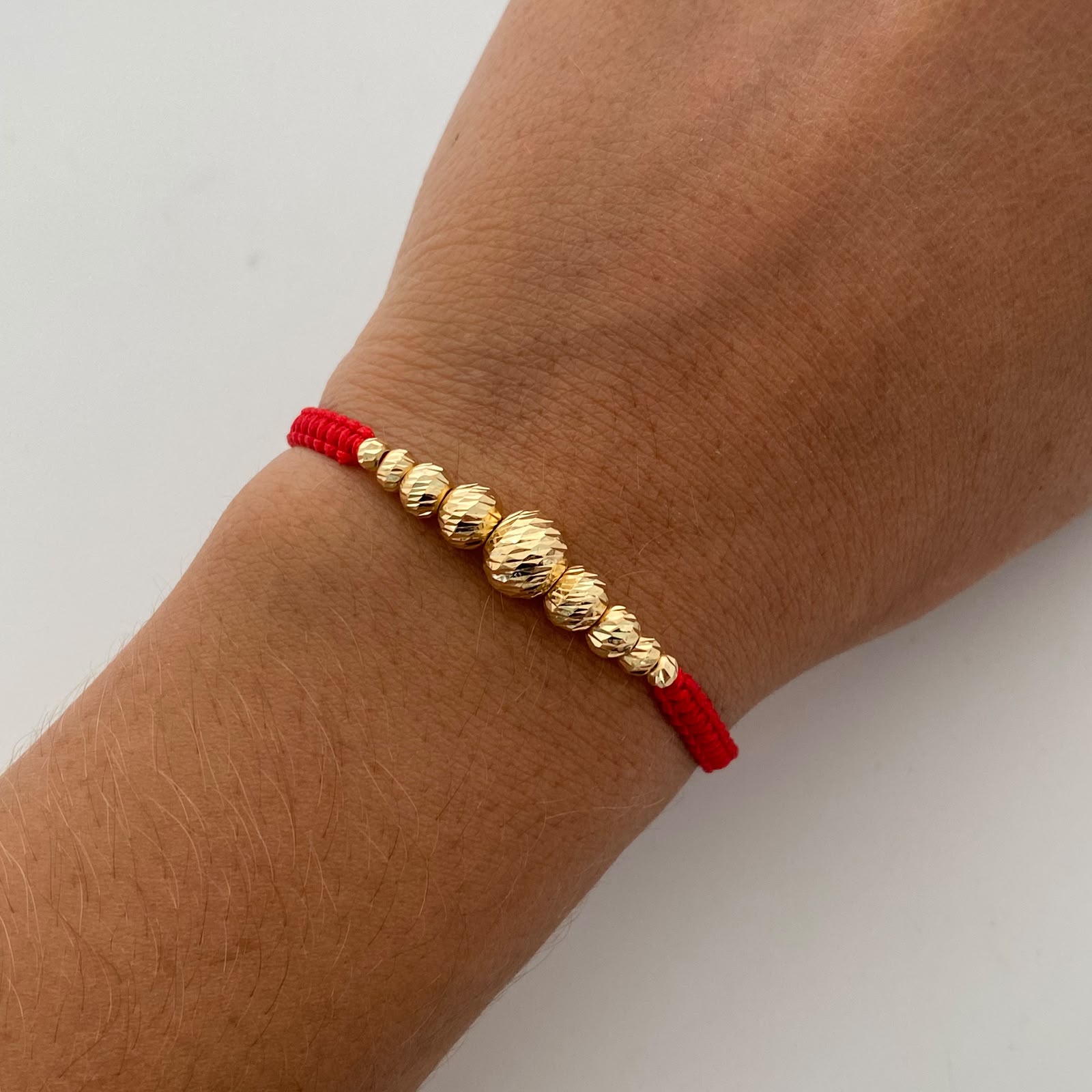 Pulsera tejida Bolas Diamantadas 8,6,5,4,3 mm roja Oro amarillo 18k 0,85 Gr