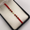 Pulsera tejida Herraje cruz lisa bolas diamantadas 4mm hilo rojo Oro amarillo 18k 0,45 Gr