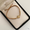 Pulsera tejida con herraje letra c y balines diamantados 4mm Oro amarillo 18k 1,25 Gr