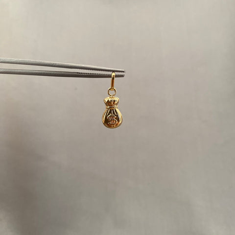 Dije bolsa de dinero oro amarillo 18k 0.60 gr / 2 cm