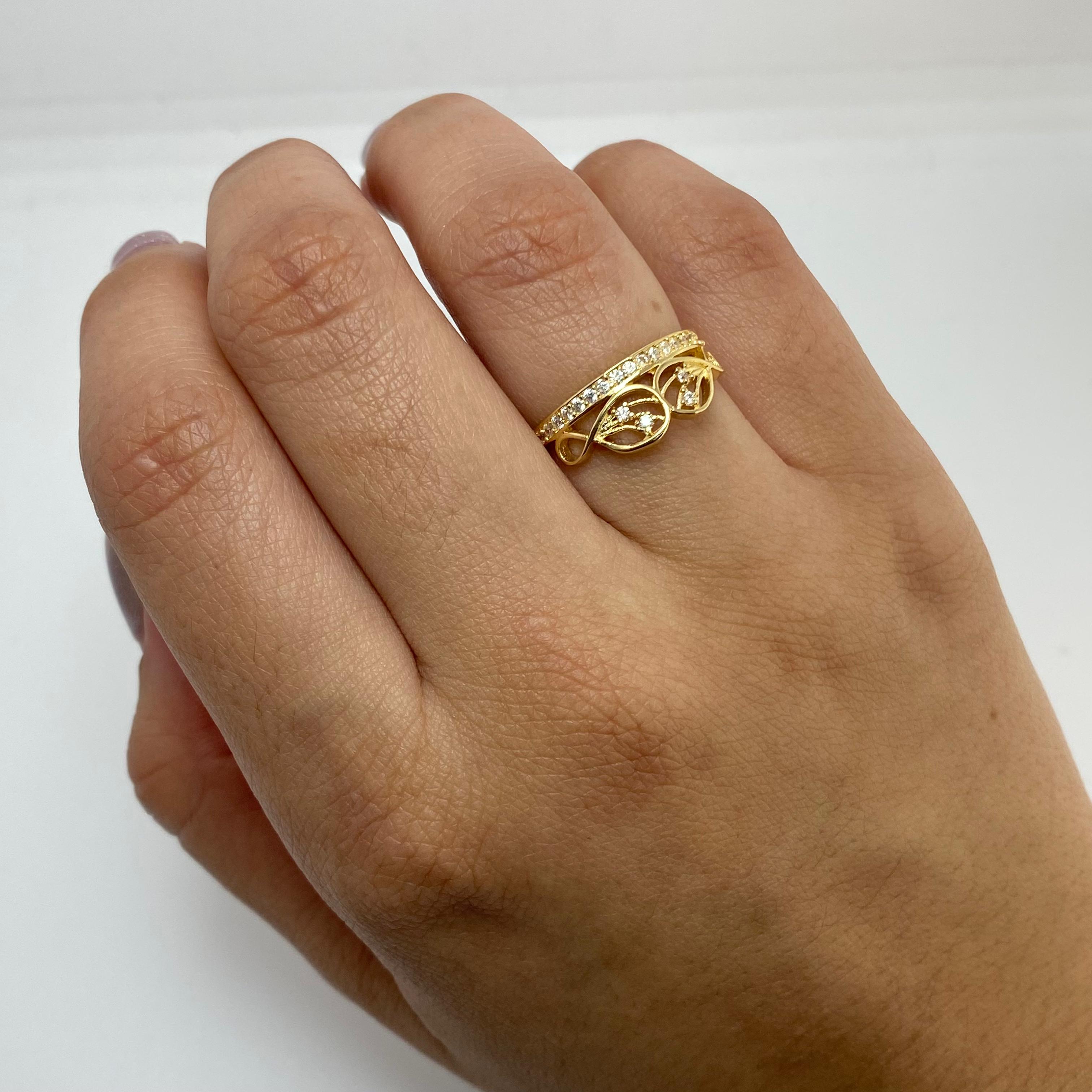 Anillo infinitos centro destellos casting Oro amarillo 18k / Talla 6 1/4 / 1,95 Gr
