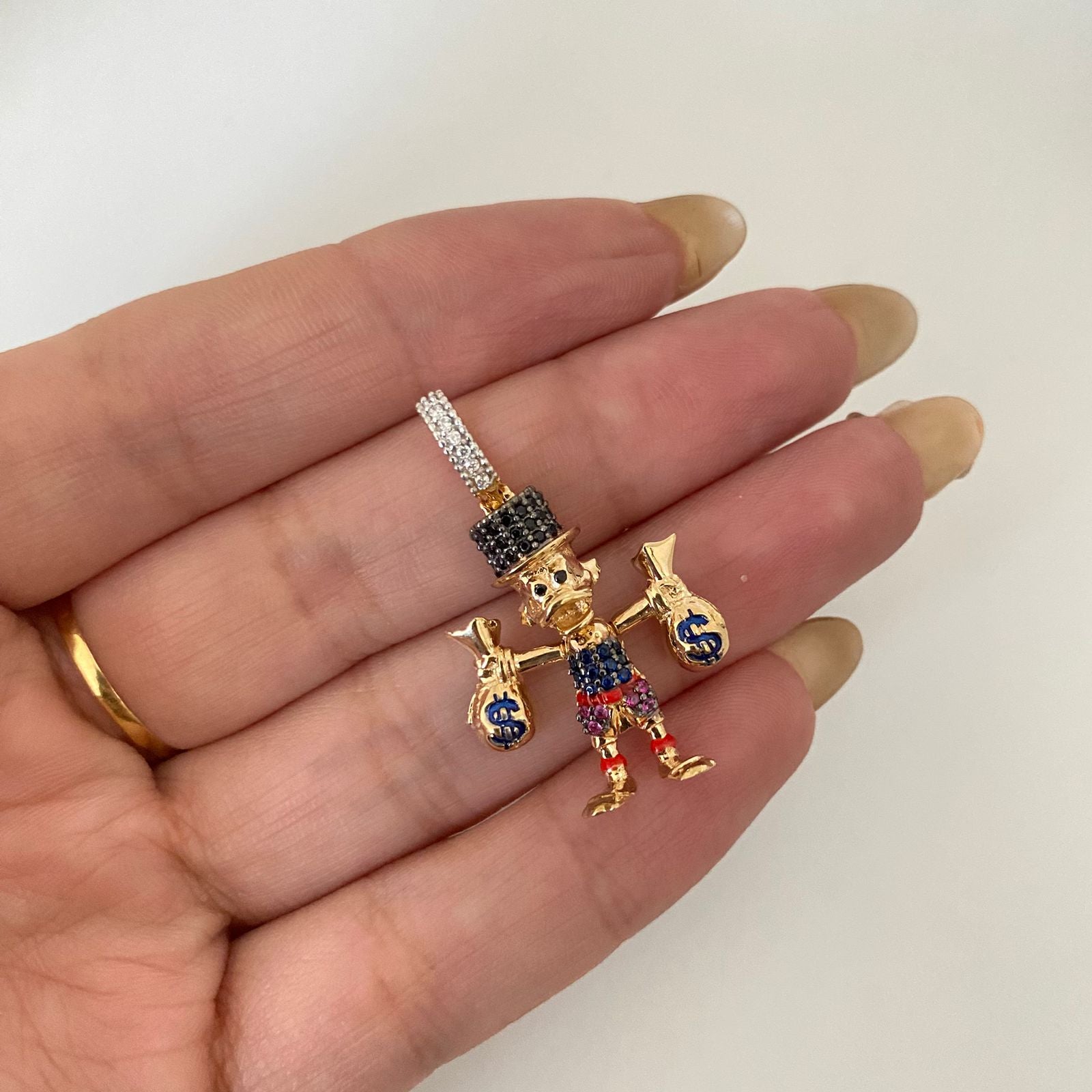 Dije tio rico casting Oro amarillo 18k 4,65 Gr / 3,5 Cm