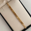 Pulsera tejida Cilindros Diamantados Hilo Beige Oro amarillo 18k 2 Gr