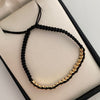 Pulsera tejida Cilindros Diamantados Hilo Negro Oro amarillo 18k 2 Gr