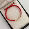 Pulsera tejida Herraje cruz bola diamantada 4mm Hilo rojo Oro amarillo 18k 0,6 Gr