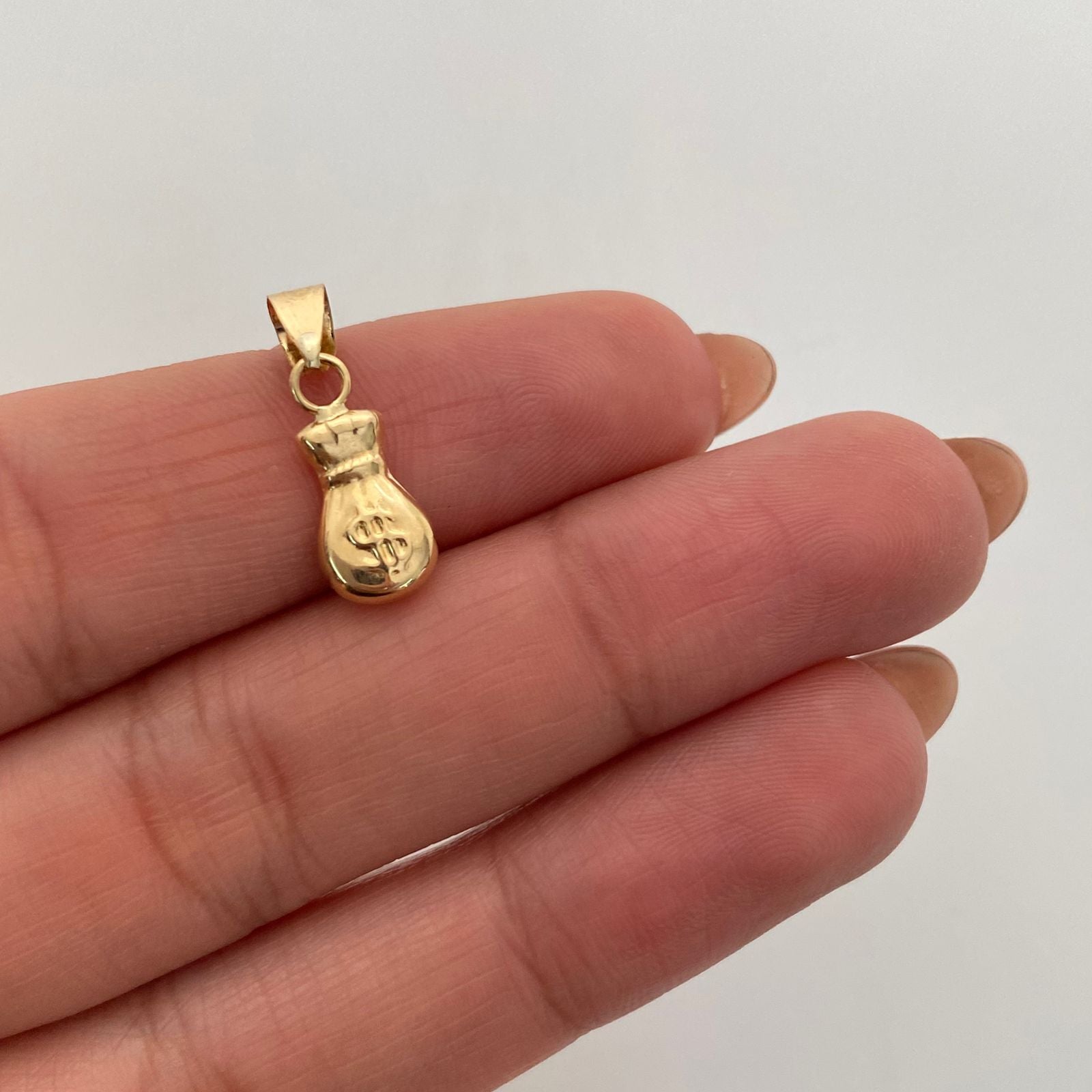 Dije Bolsa de Valores Oro amarillo 18k 0,55 Gr / 6,7 mm / 1,8 Cm