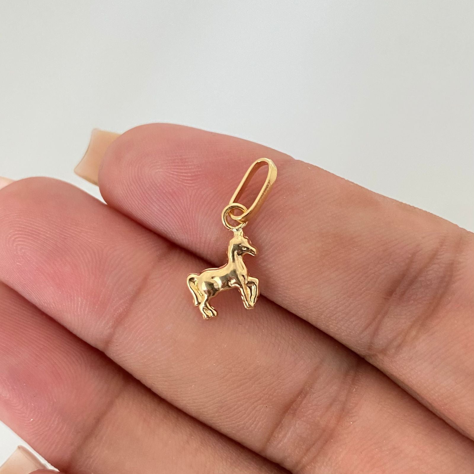Dije caballo mini Oro amarillo 18k 0,55 Gr / 2,0 Cm