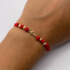 Pulsera tejida Herraje cruz lisa bolas diamantadas 4mm hilo rojo Oro amarillo 18k 0,45 Gr