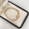 Pulsera tejida con herraje rx y bolas diamantadas 5mm y 4mm  Oro amarillo y Oro rosa 18k 4 Gr