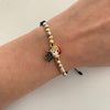 Pulsera tejida con herraje de pato y balines diamantados  Tres oros 18k 3,05 Gr